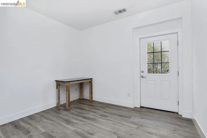 Spare room with light wood-style flooring and baseboards