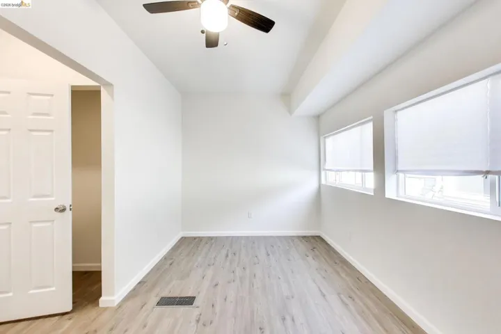 Spare room with ceiling fan and light wood finished floors