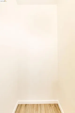 Spare room with light wood-style floors and baseboards