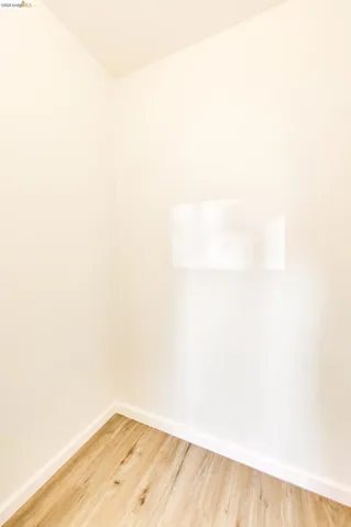 Empty room featuring baseboards and light wood finished floors