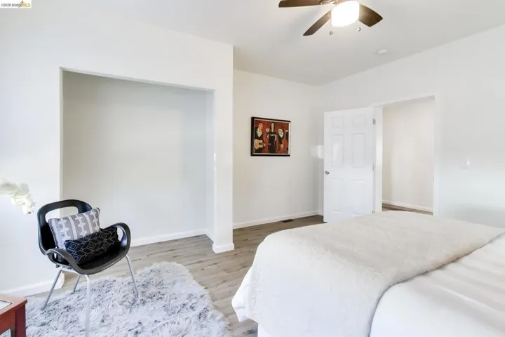 Bedroom with light wood-style floors and ceiling fan