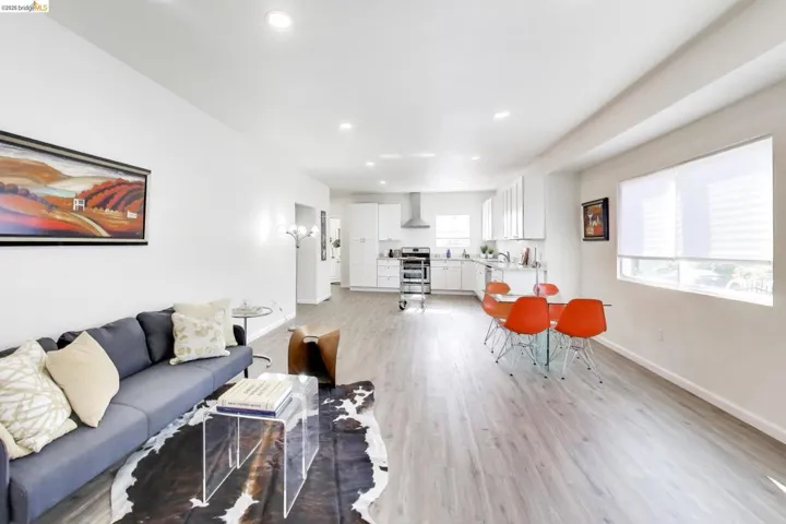 Living room with light wood-style floors and recessed lighting