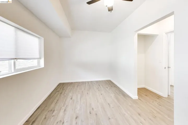 Spare room featuring light wood-style floors and ceiling fan