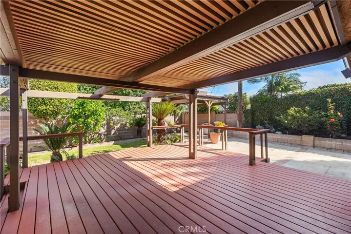 Beautiful covered deck for entertaining and access to the rest of the large backyard.