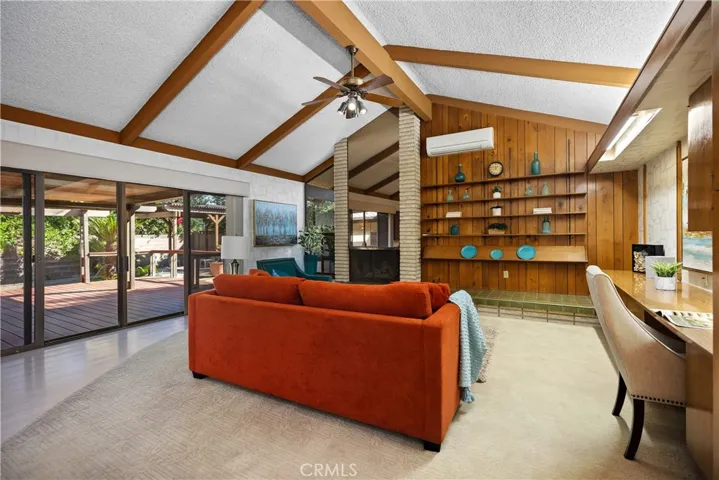 Great Room--beautiful vaulted ceiling, fireplace, gorgeous display shelving, desk and storage and direct access to the outdoor deck and backyard.