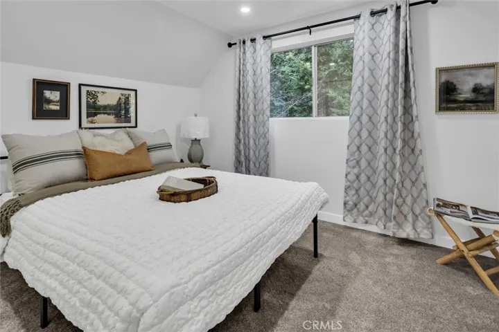 Upstairs guest bedroom with views of forest