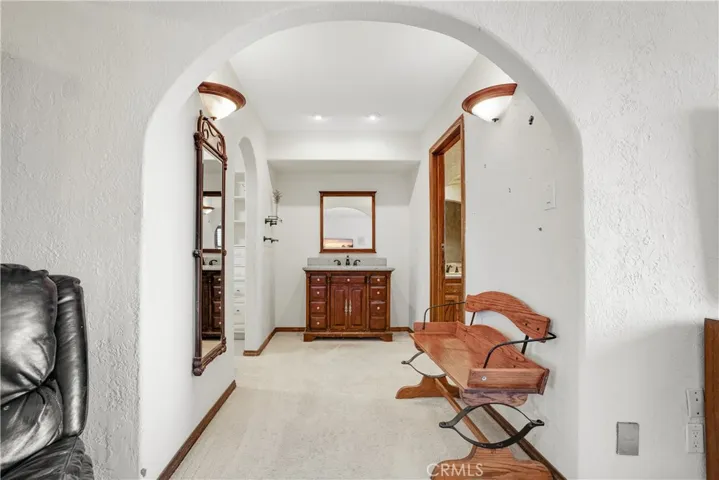 Hallway to primary closet and bathroom