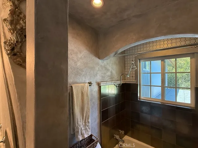 Shower/tub combination with a window for natural light