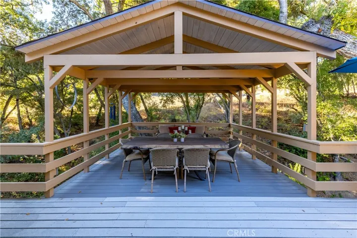 Covered back deck creates an ideal outdoor entertaining space overlooking Sheep Camp Creek below.