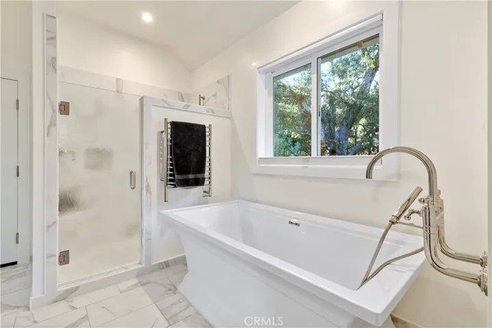 Spacious walk-in shower and freestanding tub designed for relaxation and everyday comfort.