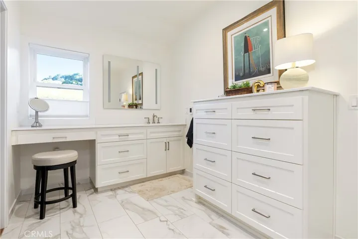 Elegant tile finishes and heated flooring elevate the first ensuite into a spa-like experience.