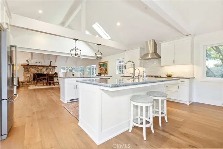 Barstool seating along both islands enhances functionality and supports casual entertaining.