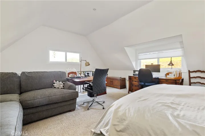 Loft window overlooks the property while inviting beautiful natural light into the space.