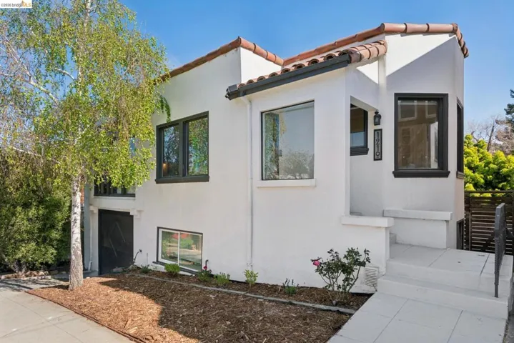 Mediterranean / spanish-style house with stucco siding and a tile roof