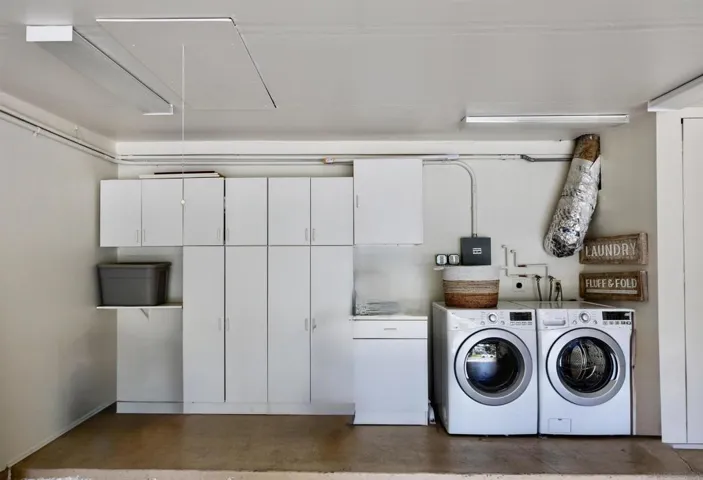 Washer/dryer in garage with built in cabinets