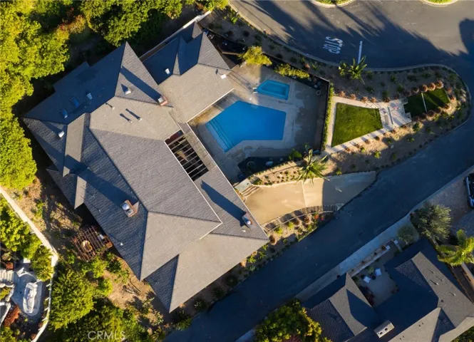 Aerial perspective showcasing the full estate: front promontory park-like overlook, backyard gazebo nestled in fruit trees, central private pool and spa, and endless ocean views enveloping this nearly 7,000 sq ft gem on a rare 17,600 sq. ft. corner lot
