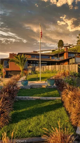 The property's signature promontory pointe: a secluded grassy enclave with bench for intimate sunset viewing over the ocean