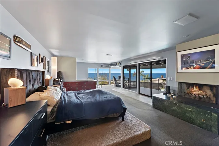 Master bedroom Suite with private ocean viewing deck, fireplace, direct pool access