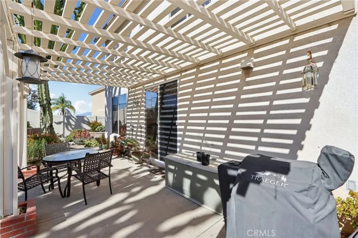 Shaded backyard patio with pergola