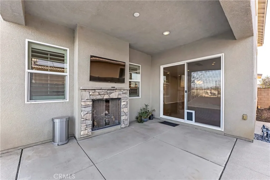covered patio with fire place and TV