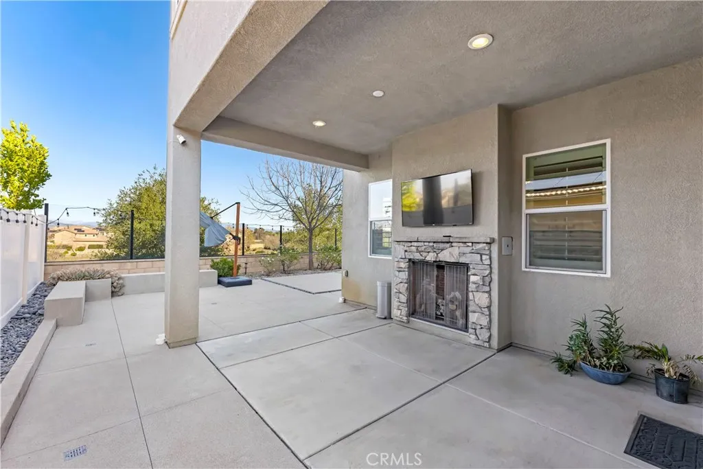 covered patio with fire place and TV