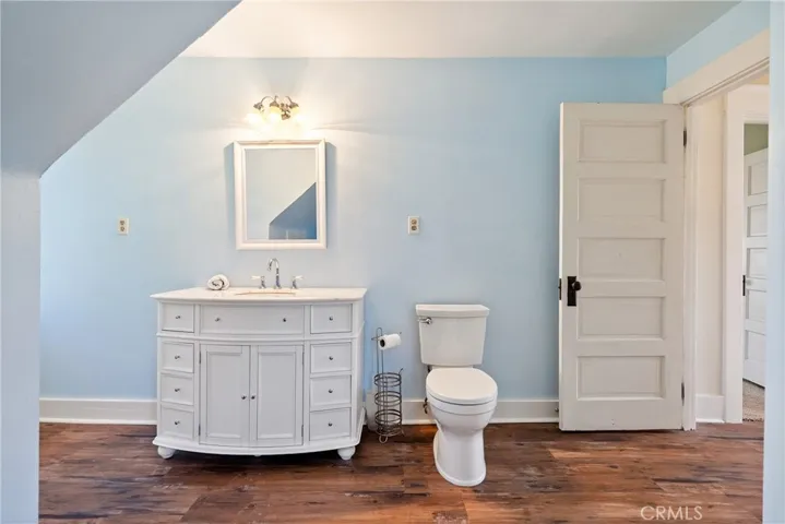 The primary bathroom boasts a newer vanity and laminate wood flooring.