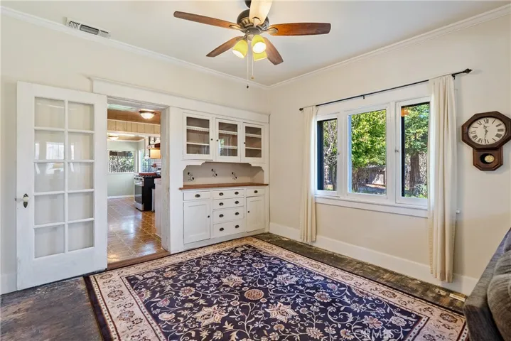 Dining area with crown molding and timeless built-in buffet.