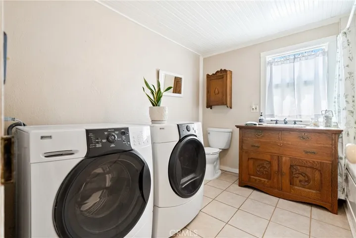 The main bathroom is located between the guest bedrooms and also houses the laundry area.