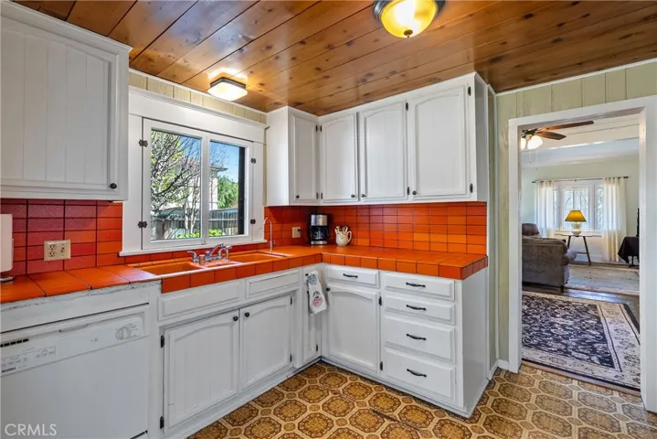 Cozy kitchen with tongue and groove ceiling.