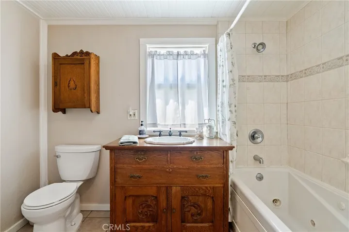 Antique vanity and a jetted tub/shower combination.