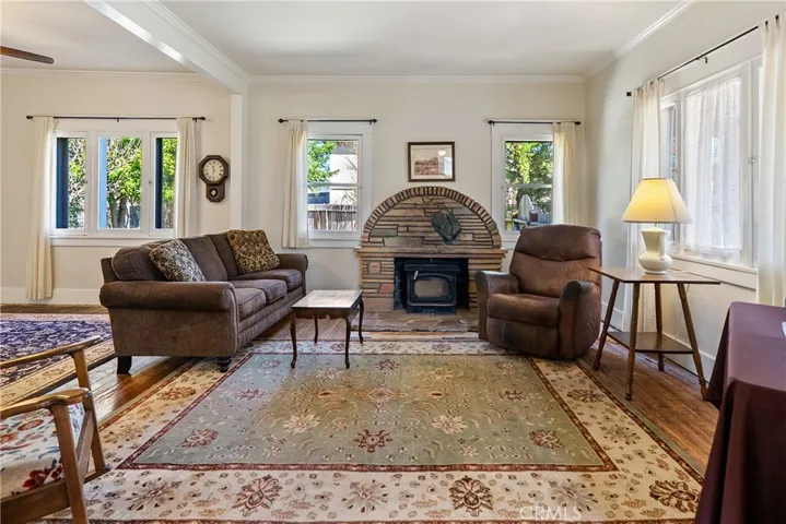 The inviting living room is surrounded by windows that bathe the room with natural light.