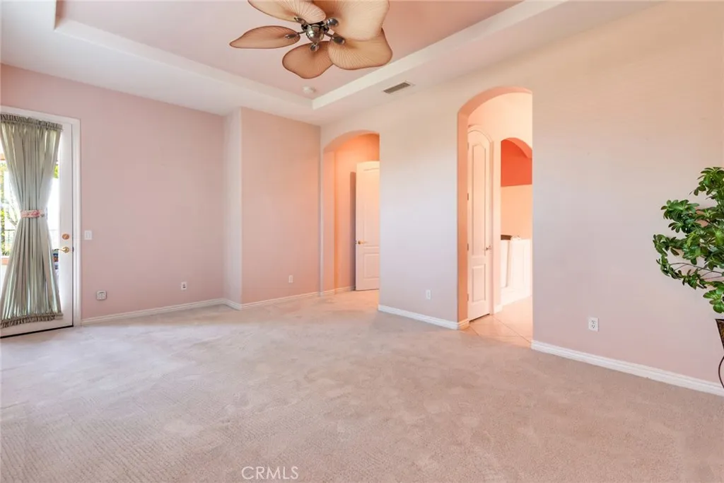 "As is" photo of Primary Bedroom, shows door to outside back Patio