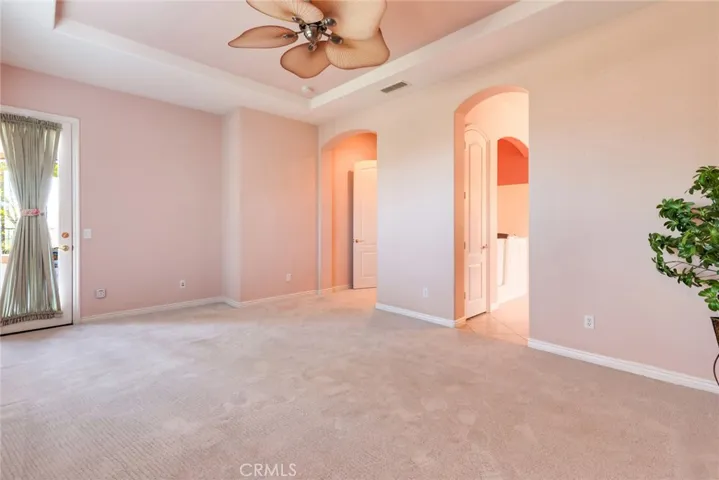 "As is" photo of Primary Bedroom, shows door to outside back Patio