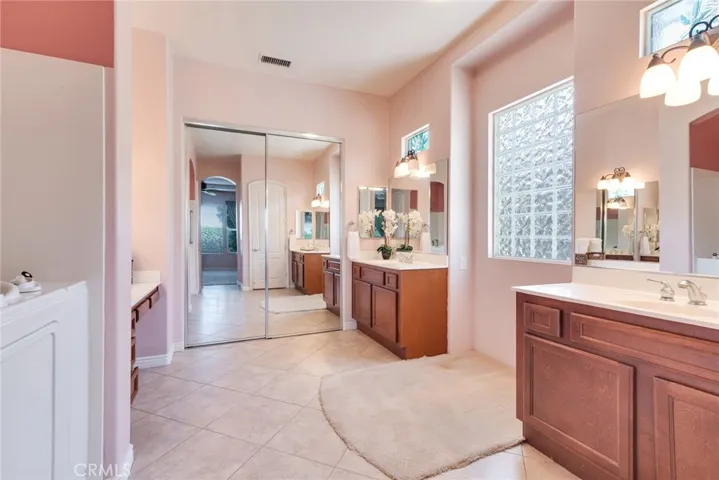  "His & Hers" mirrored Vanities grace the Master Bathroom. Double-Mirrored Doors lead to a Huge Walk-In Closet