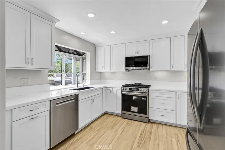 New upgraded updated Kitchen with new quartz counter tops and backsplash, stainless appliances, Cabinets, recessed lights, under cabinet light fixtures