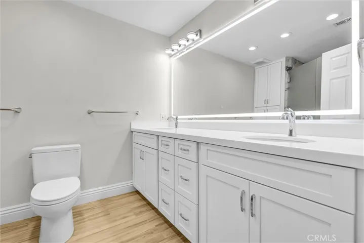Primary bath #1 with new cabinets and quartz counter tops and backsplash plus lighted mirror, new floorings and light fixtures.