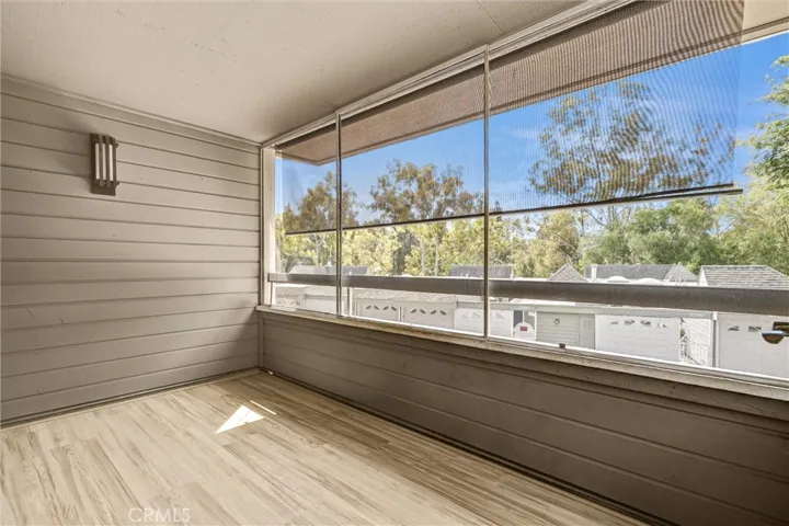 Enclosed, screened private Balcony with new floorings with views of trees and hills.