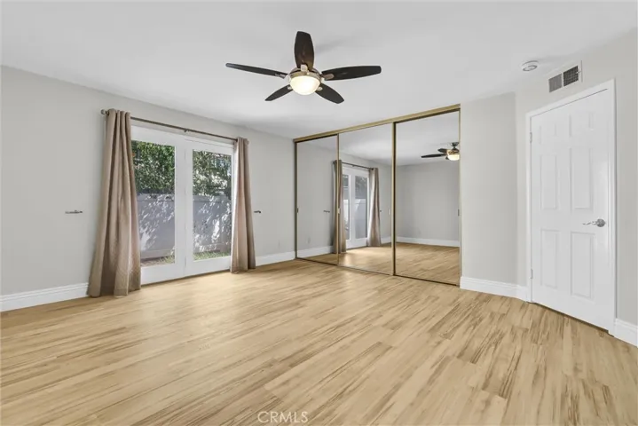 Primary bedroom #1 with mirrored wardrobe doors and organizers