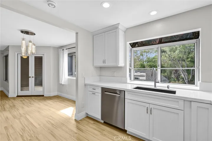 Newly installed glass bay windows, dishwasher, sink and faucet and dining area