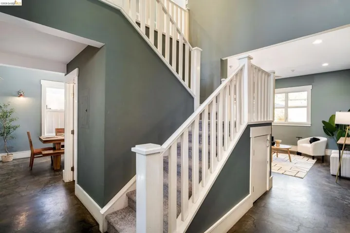 Stairway featuring recessed lighting, concrete flooring, and radiator heating unit