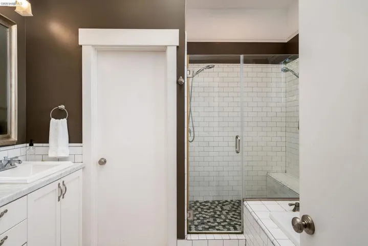 Bathroom featuring vanity and a shower stall