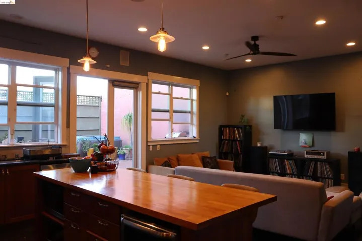 Kitchen featuring open floor plan, wood counters, and dark wood finish cabinets