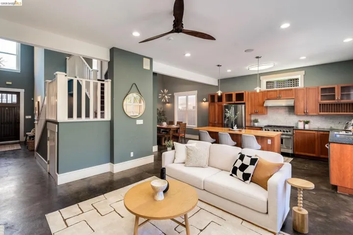 Living area featuring finished concrete floors, a ceiling fan, recessed lighting, and plenty of natural light
