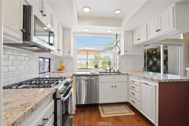 Kitchen looking out into backyard and view