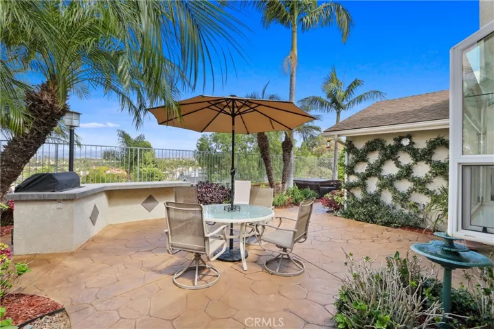 Back patio with built-in BBQ and above ground hot tub