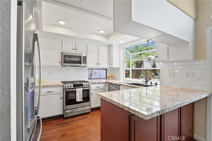 Kitchen with granite counters and garden window