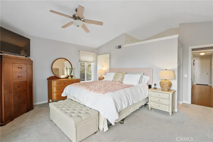 Master bedroom with vaulted ceiling and fan