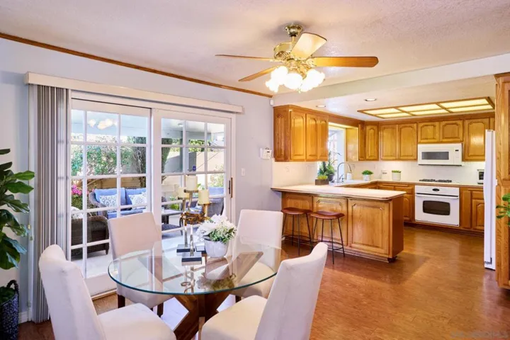 Kitchen/dining sliders lead to covered patio and backyard.