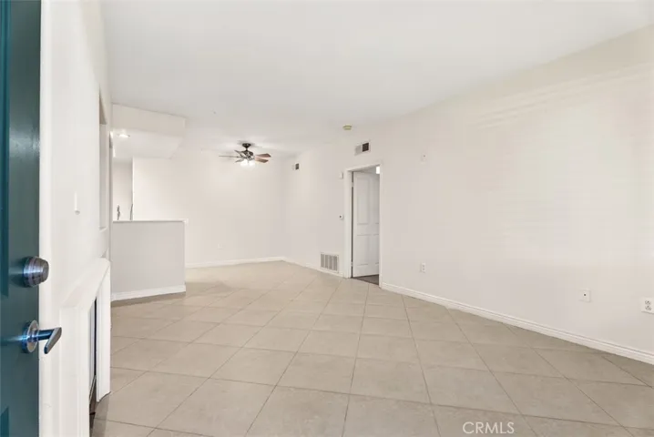 Living Room – Bright main living area with tile flooring, neutral finishes, and an open layout that creates an easy flow throughout the home.