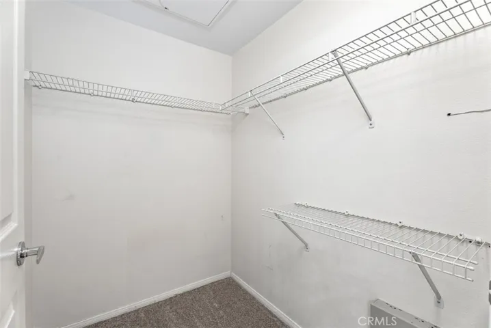 Walk-In Closet – Generous walk-in closet offers ample hanging space and built-in shelving for organized storage.